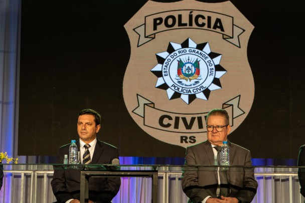Na foto aparecem Secretário da Segurança Pública, coronel Vanius Cesar Santarosa  e o governador do RS, Ranolfo Vieira Júnior, sentados na formatura dos 247 agentes da PC em solenidade na Puc.